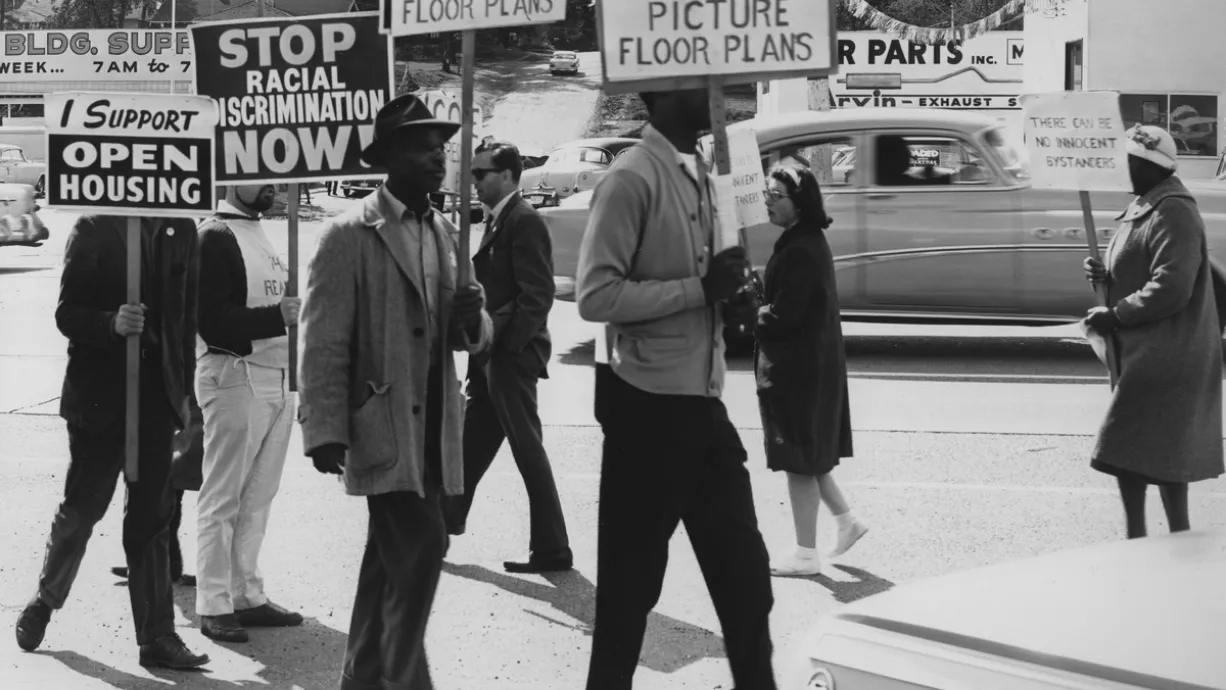 People protesting housing discrimination at rally in 1964.